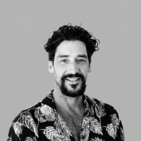 Black and white portrait of Mick Becker, Dual Horizons business broker, in leaf print shirt